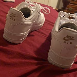 Women Nike forces white with gold brace on shoes